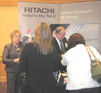 Attendees visit the Hitachi booth